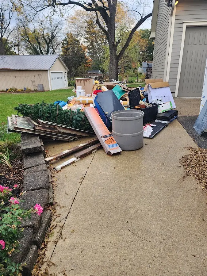 Dumpster being loaded with debris for 10 Yard Dumpster Rental in Algona